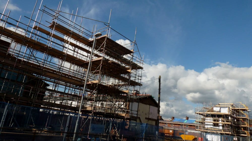 New build housing development under construction in Surrey with scaffolding