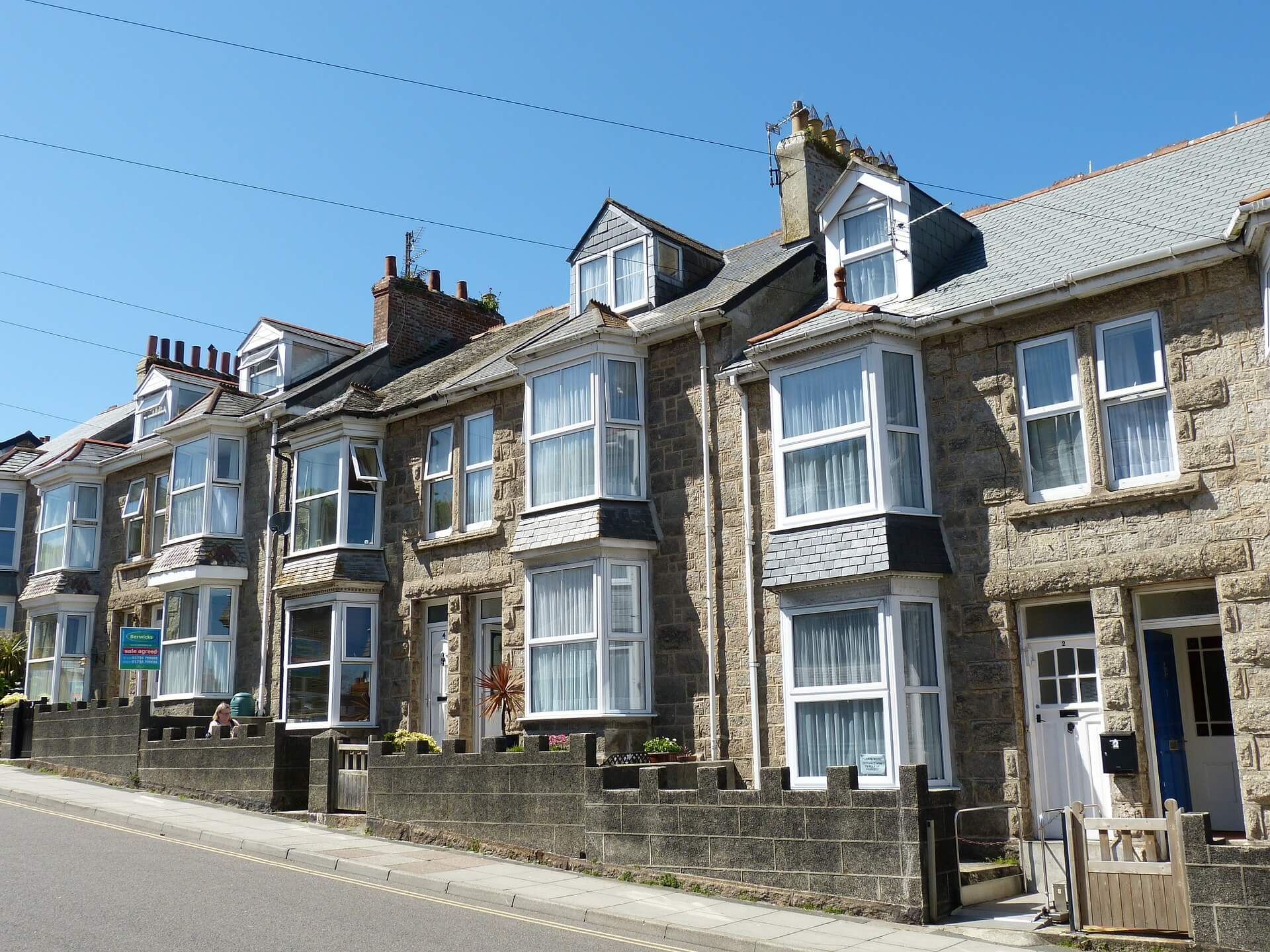 Two adjacent Surrey terraced houses showing party wall shared between properties affected by extension works