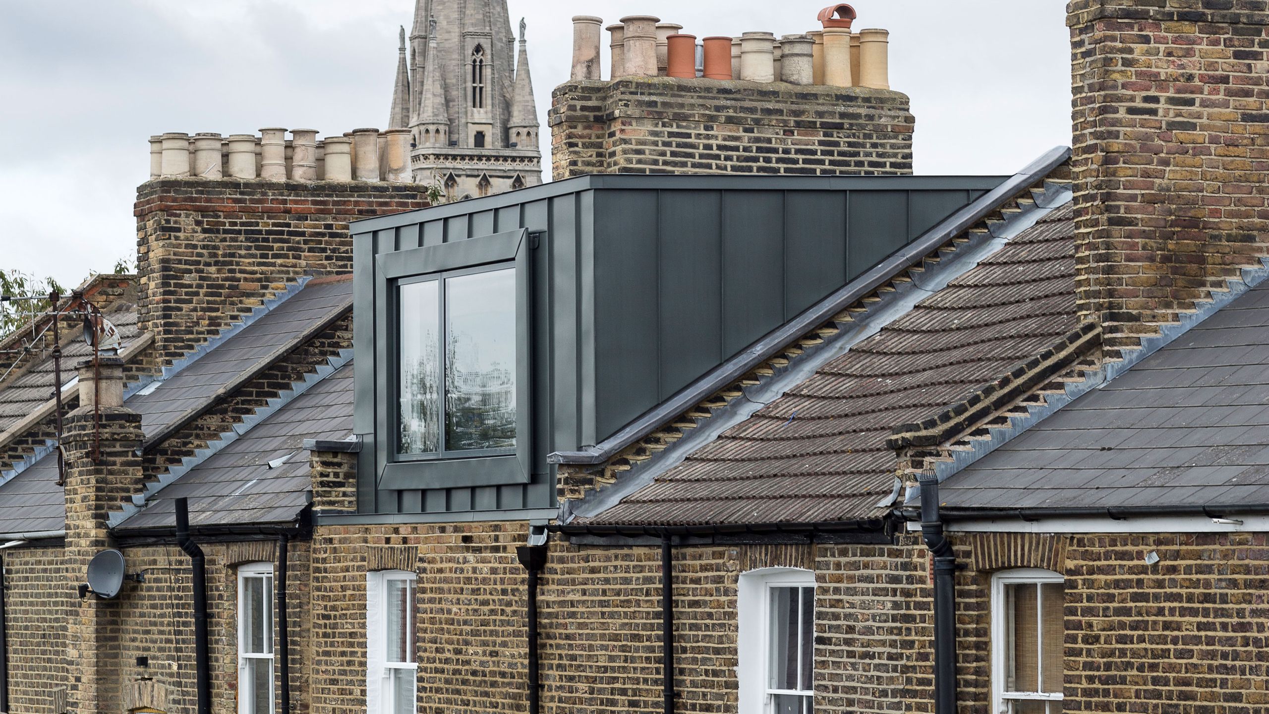 Party wall between two British terraced houses with loft conversion scaffolding